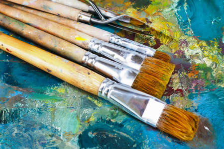 artist's palette with oil paints and brushes for paintingの写真素材