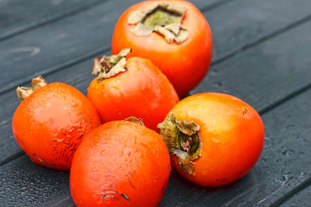 persimmon, Fresh ripe persimmon on wooden table fruits on rustic table, tropical fruit
