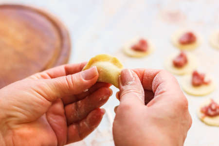 homemade meat dumplings, raw tortellini and ravioli on the table Russian cuisineの写真素材