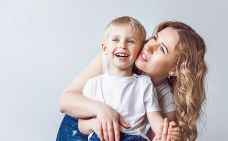 happy baby boy playing and hugging mum, happy family enjoying life, soft focusの写真素材