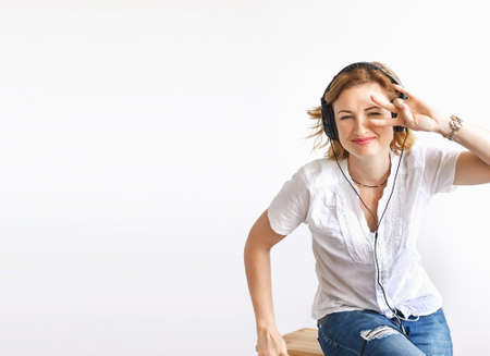Beautiful girl in headphones, soft focus, on white background