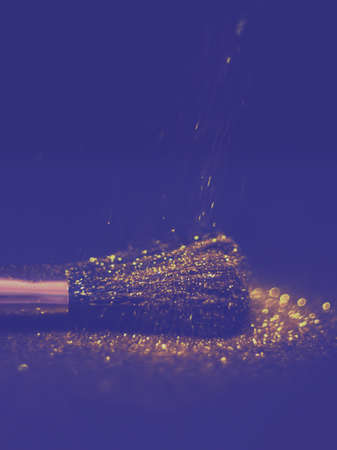 texture of gold glitter on the makeup brush and design. On a black background. Selective Focus - Imageの写真素材