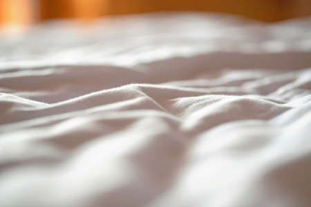 view of the morning crumpled bed in the hotel room. Cozy morning atmosphere .Hotel Ukraine.Shallow depth of field. selective focusの写真素材