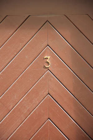 Authentic wooden door with number 3.