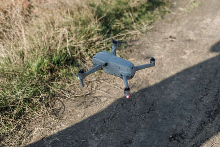 The DJI drone is ready to fly. Ukraine, Nikolaev - November 21, 2021 Drone with a quadrocopter with a camera flying in the air.の写真素材