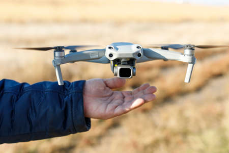 Pilot hand launching drone drone ready to take off. modern unmanned technologies. delivery of parcels by drones by air.の写真素材