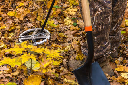 metal detector at work in the forest. Search for treasure and ancient values. Archeology. Man with a metal detector. Minesweeper- Image.Main object in motionの写真素材