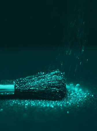 texture of gold glitter on the makeup brush and design. We have a black background. Selective Focus - Pictureの写真素材