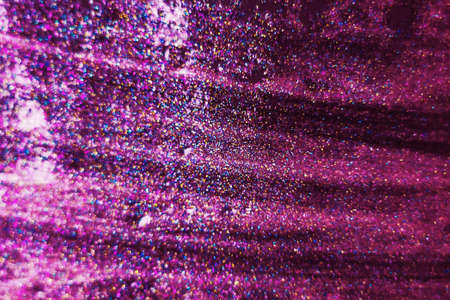Gold and pink glitter on a black background as a background. Abstract christmas background with festive lights and copy space - magic bokeh sparkle. unfocused, focused - Imageの写真素材
