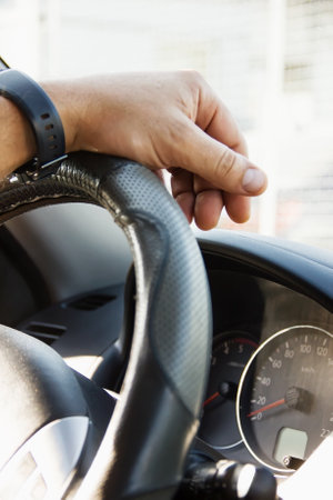 Selective focus male hand on the steering wheel, car driving and dashboard. Travel Background - Imageの写真素材