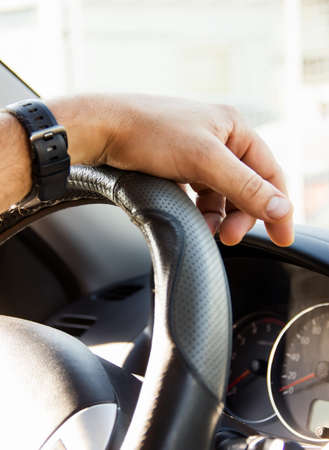 Selective focus male hand on the steering wheel, car driving and dashboard. Travel Background - Imageの写真素材
