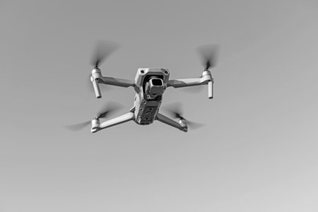 close-up bottom view of a small drone flying in the air. Place for text.の写真素材
