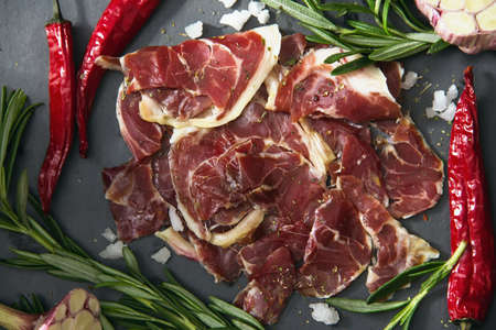 Hamon.Tasty ham sliced ââinto strips on a wooden background with spices and fresh thyme. A serving of lean pork. meat product. Food Photography - Image. View from aboveの写真素材