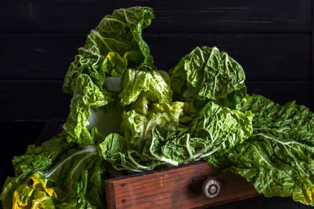 Fresh Chinese cabbage in a cut on a dark wooden background. Diet nutrition. Vegetables and fruits. Dark Food Photographyの写真素材
