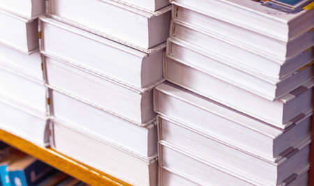 books on a shelf in the library, reading, and science education, stack of books piled volume hardcoverの写真素材