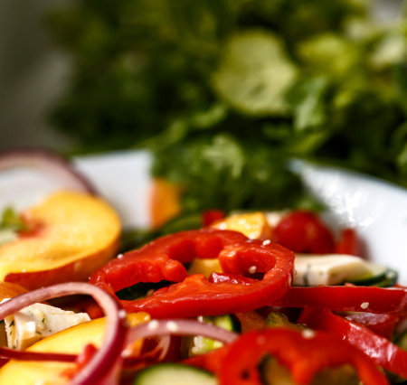 Salad of bell peppers, cucumbers, peaches, celery, red onions and sesame seeds. Vegan food and snacks. Clean eating, raw food, detox, plant based diet concept.の写真素材