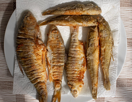 Delicious fish cooked in a frying pan with butterの写真素材