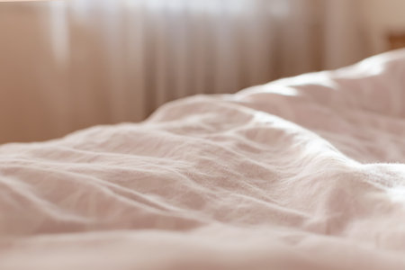 view of the morning crumpled bed in the hotel room. in the morning light. Cozy morning atmosphere. unmade bedding for sleeping. Shallow depth of field. selective focus. color 2022の写真素材