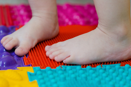 children's feet on an orthopedic matの写真素材