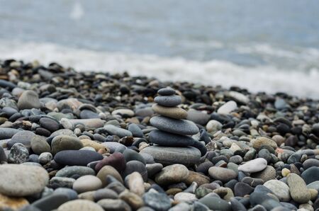 tower of stones on the coast of the sea with pebblesの写真素材