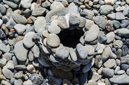 big tower of stones on the coast of the sea with pebblesの写真素材