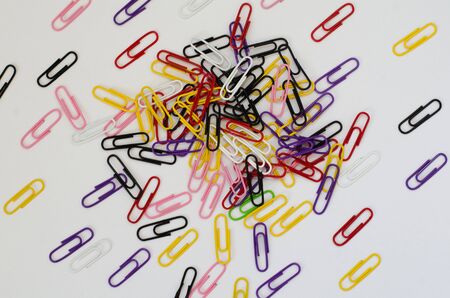 a bunch of colorful paper clips on white paperの写真素材