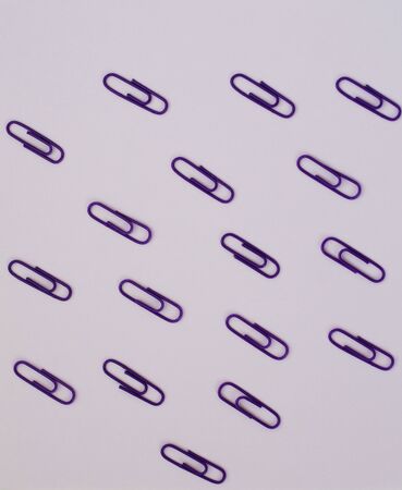 lots of purple paper clips on lilac paperの写真素材