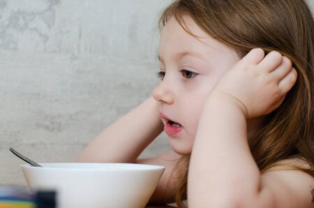 tghe child doesnât want to eat porridge at the tableの写真素材