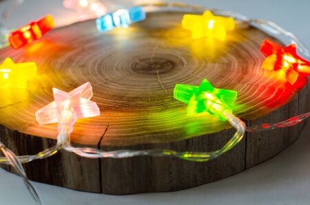 loft background with colored garland stars and round saw cut treeの写真素材