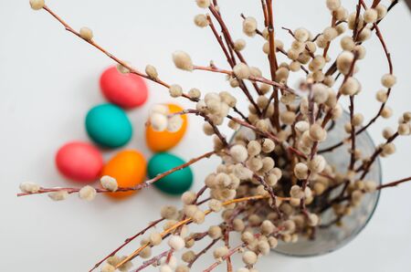 spring still life with a bouquet of willow with colored Easter eggsの写真素材