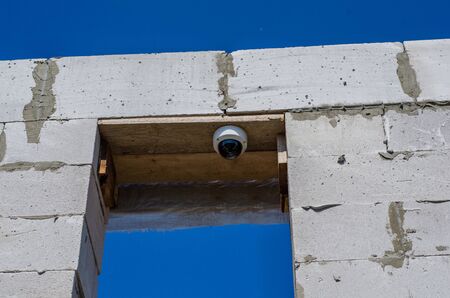 CCTV on an unfinished brick building