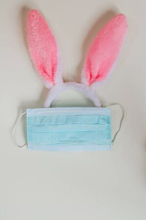 bunny ears are protected in a medical mask on a white background.の写真素材