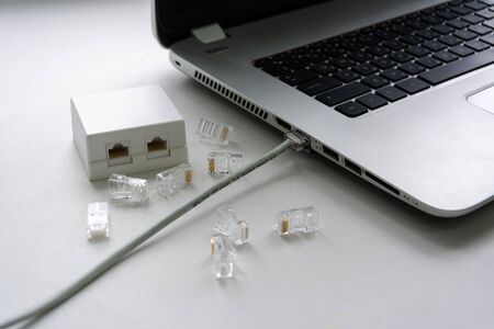 cable twisted pair connected to a laptop, connectors and Internet outletsの写真素材