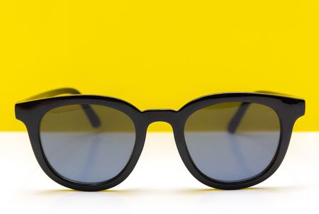 summer has come. sunglasses on a yellow background