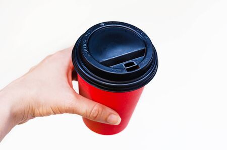 disposable paper red cup of coffee in hand. waste recyclingの写真素材