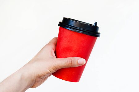 disposable paper red cup of coffee in hand. waste recyclingの写真素材