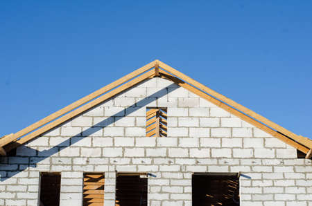view of the unfinished gas-block house with a wooden roof. construction of housesの写真素材