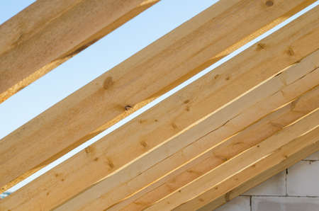 wooden bars against the sky. roof construction inside view