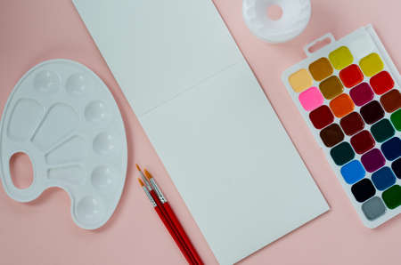 art school supplies, for drawing, paints, brushes, palette, sketchbook, water jar