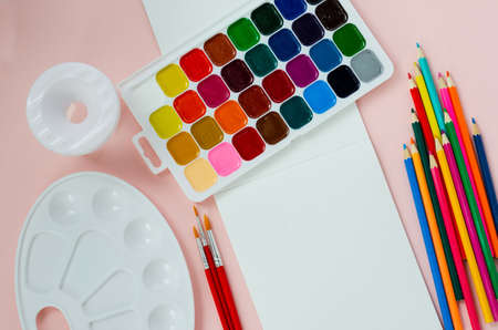 art school supplies, for drawing, paints, brushes, palette, sketchbook, water jarの写真素材