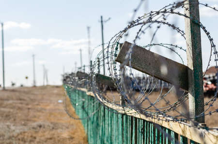 perspective view of barbed wire on a fence