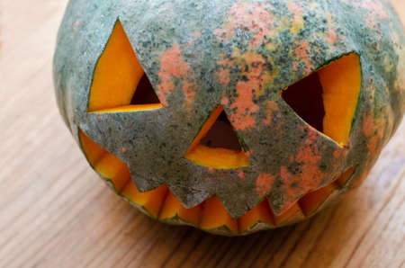 scary smiling pumpkin halloween lantern on table. view from aboveの写真素材