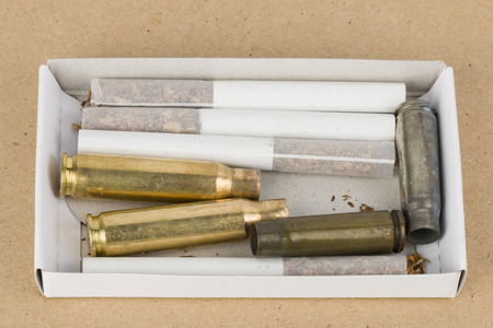 Some cigarettes and new bullets の写真素材