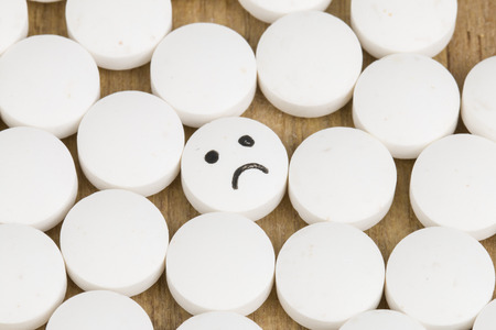 Sad emoticon on Medicine pillsの写真素材