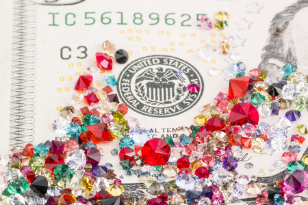 Collection of many different natural gemstones and banknotes  の写真素材