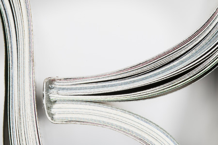 Roll of magazine on white backgroundの写真素材