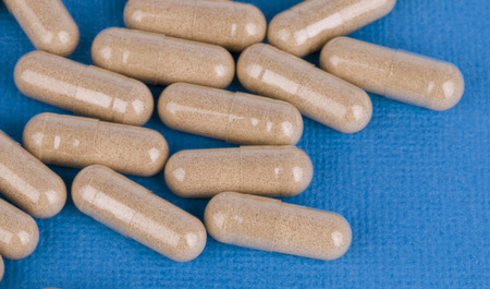 Pill on blue background - Stock Image macro 
