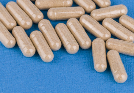 Pill on blue background - Stock Image macro 