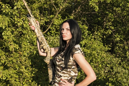 Beautiful woman hunter with Rifle. Stock Image.の写真素材