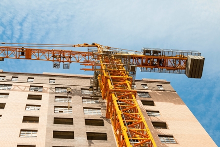 Rostov - on - Don, Russia - August 27, 2015: Crane and building construction site against blue sky, established in Lenina avenue in Rostov - on - Don.のeditorial素材